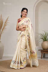 Tissue Onam saree with floral prints and a gold border